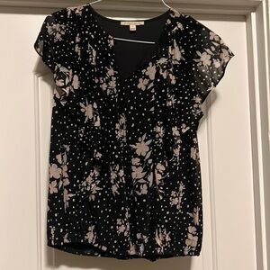 Super cute dressy top with ruffle detail down the front.